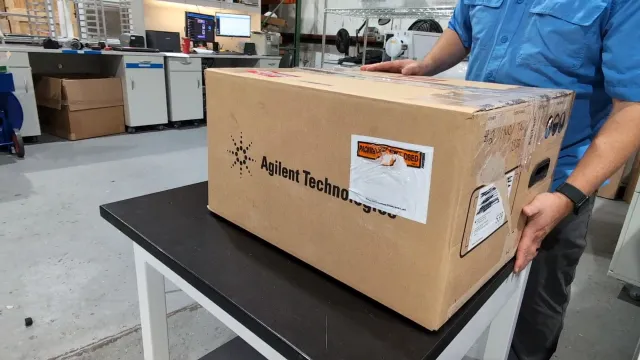 A packed, labelled instrument carton going onto a cart at AMP Tech