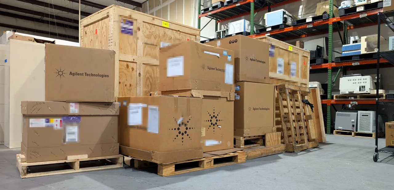 Crated and boxed Agilent instruments on pallets in AMP Tech's Longwood, Florida warehouse