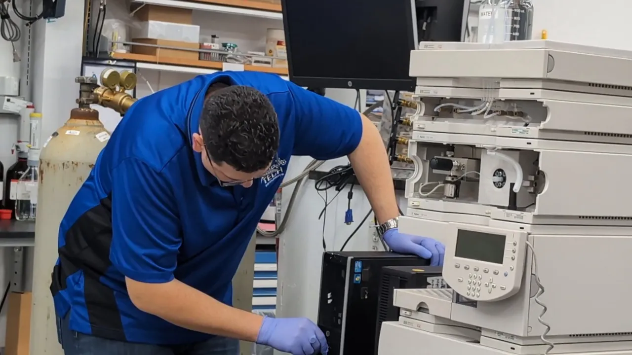 An AMP Tech technician servicing an instrument stack at AMP Tech's service facility