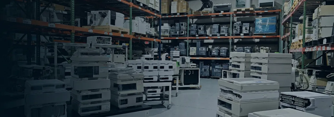AMP Tech warehouse shelving filled with HPLC, mass spectrometry and analytical lab equipment
